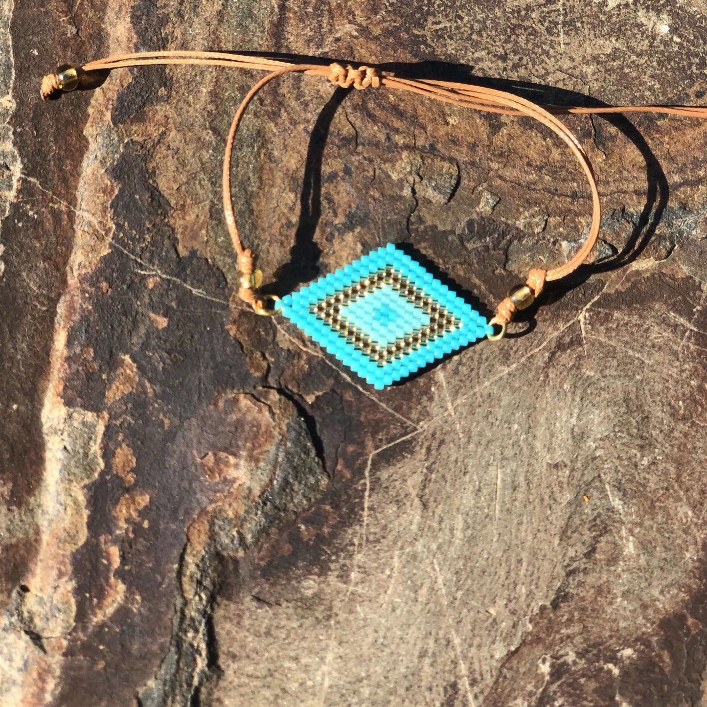 Blue gold miyuki bead bracelet on wood