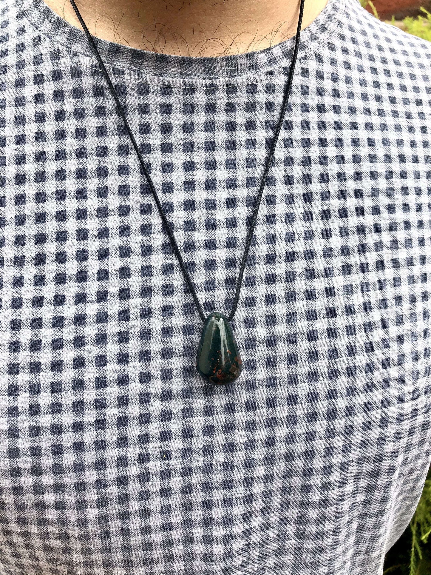 Bloodstone black cord pendant on male 