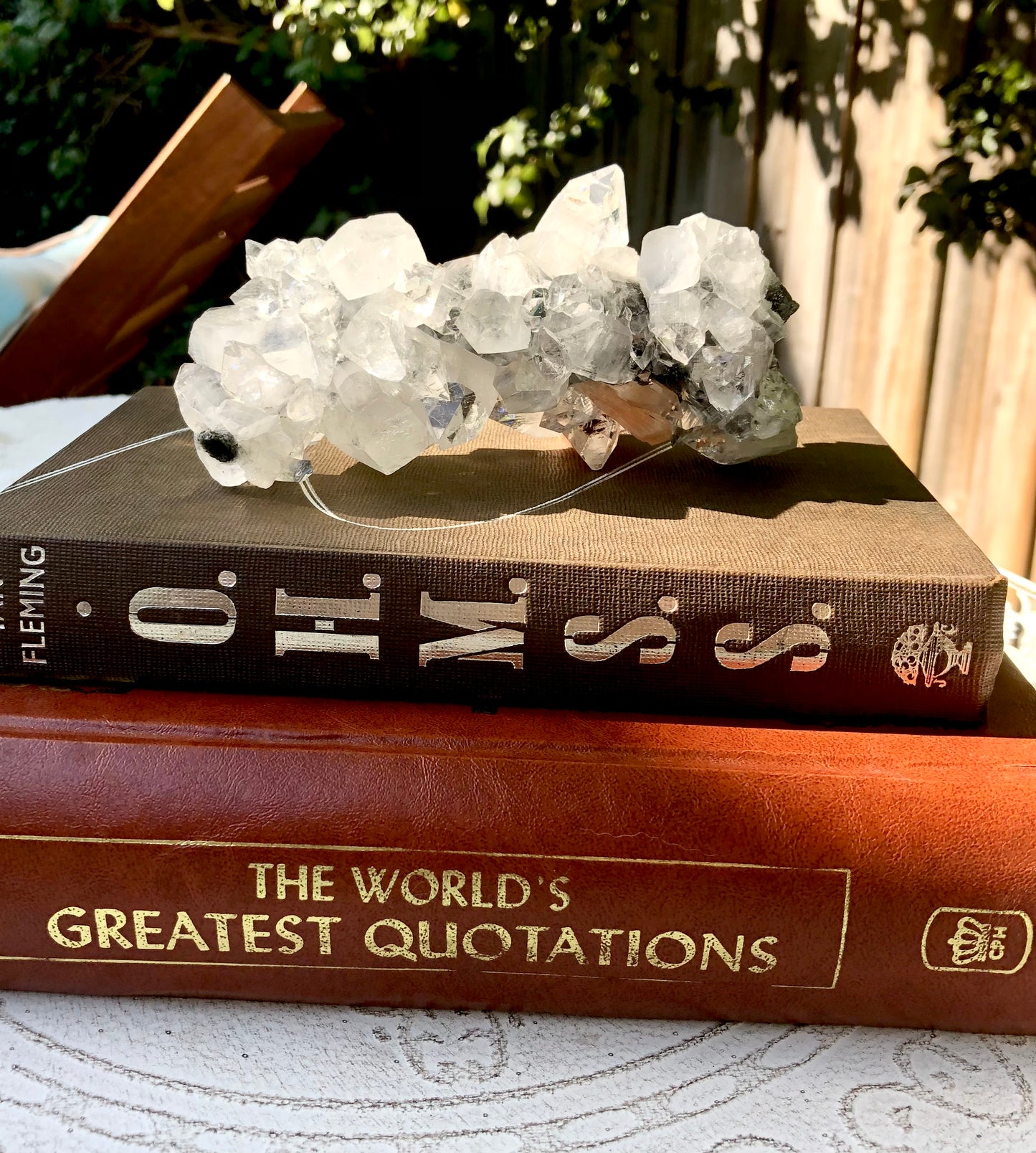 Apophysllite crystal specimen on books